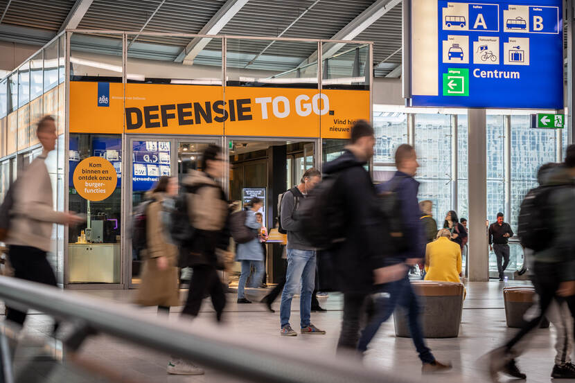 Reizigers op Utrecht Centraal lopen langs de stand van Defensie.