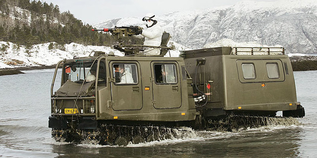 Een Bandvagn 206 D6 in het water met op achtergrond een besneeuwd landschap.