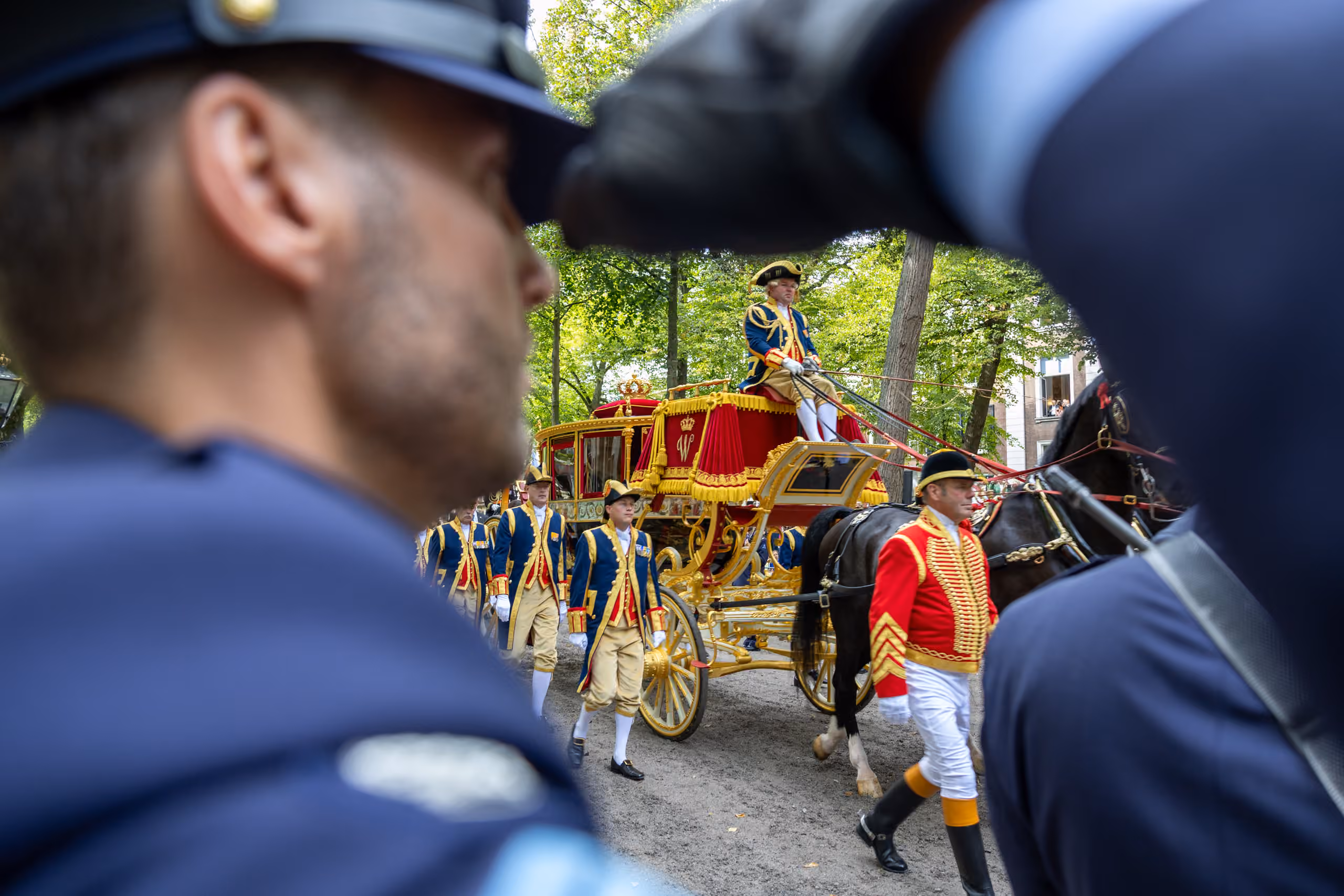 Een militair brengt een groet uit naar de inzittenden van de Glazen Koets.