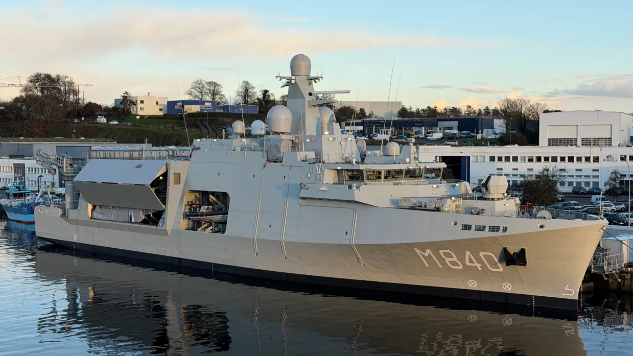Het grijze marineschip ‘Vlissingen’ aan de wal. Aan de zijkant is in grote, witte letteers ‘M840’ te lezen.