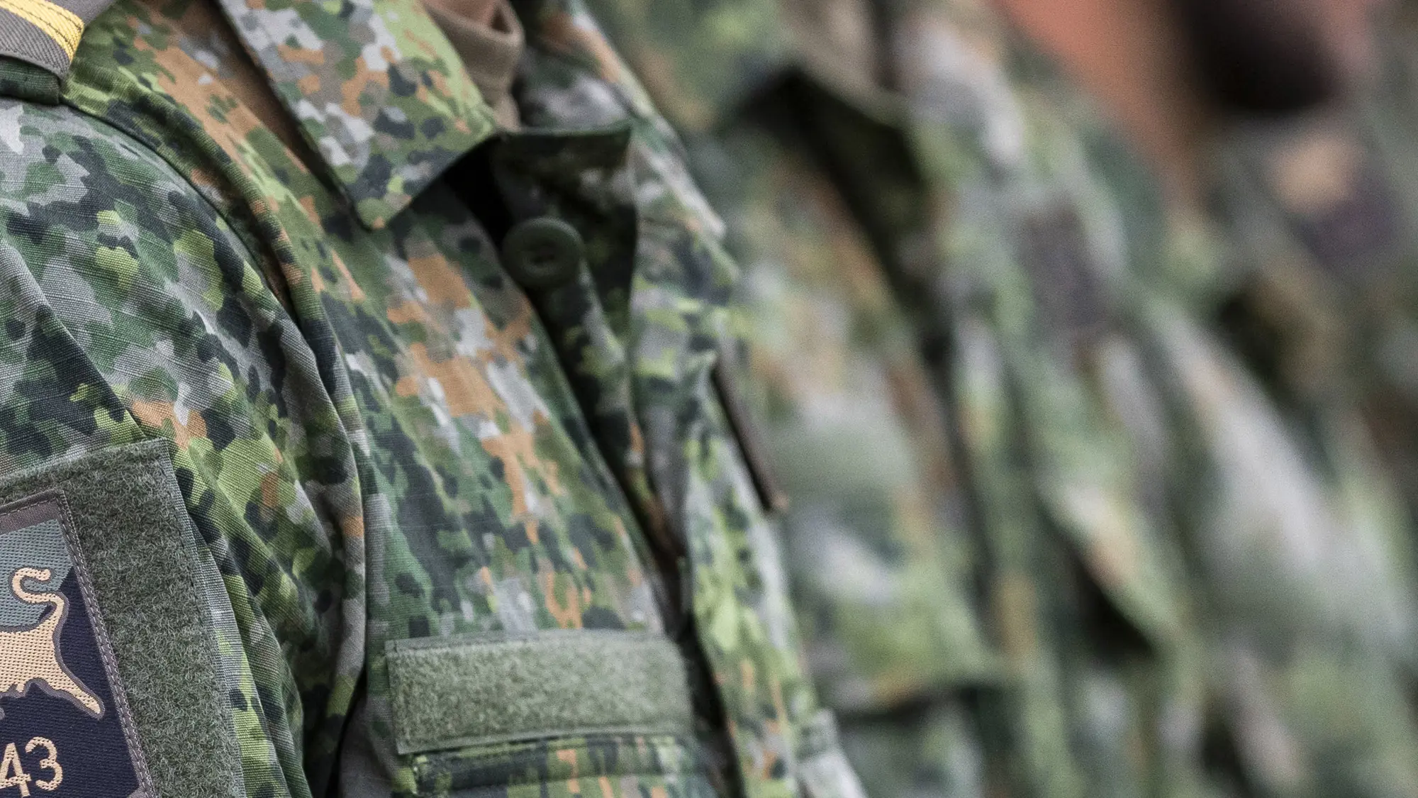 Close-up van militair met embleem op schouder.