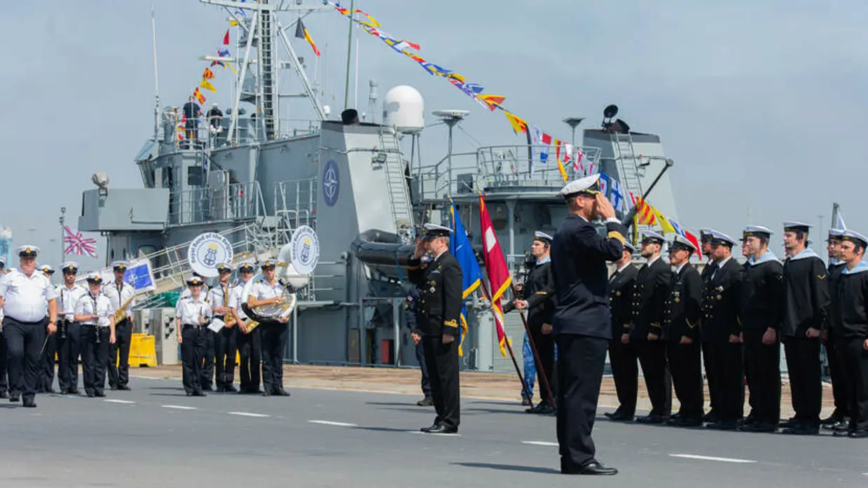 Militair ceremonieel aan de kade bij marineschip.