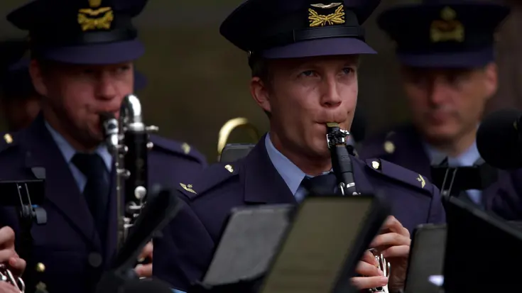 3 militairen met muziekinstrumenten. 