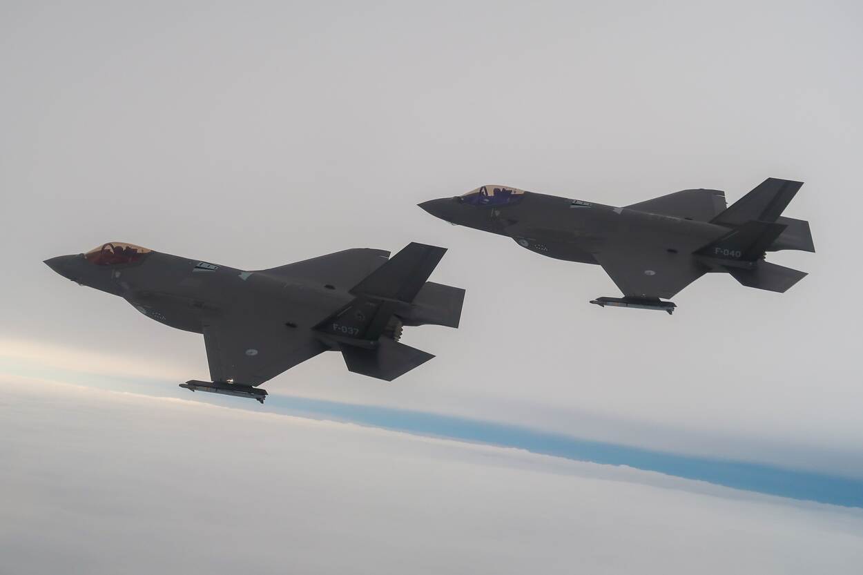 Two F-35 fighter planes in the air.