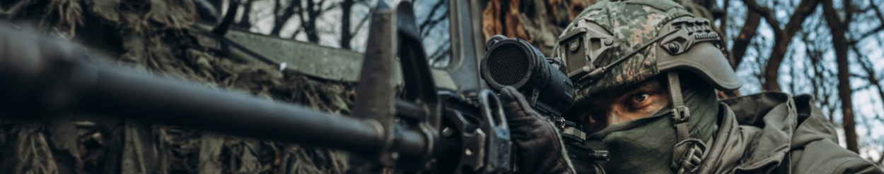 Gecamoufleerde militair met wapen.