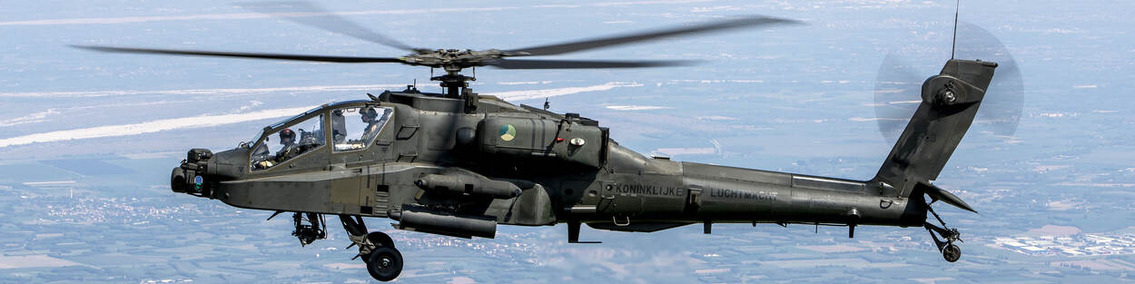 Een Apache-gevechtshelikopter hangt in de lucht.