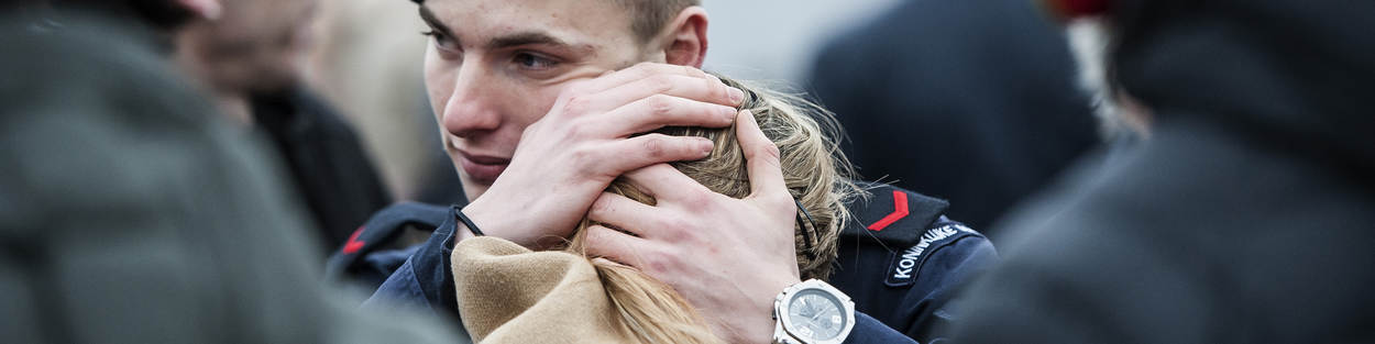 Marineman neemt afscheid van vrouw.