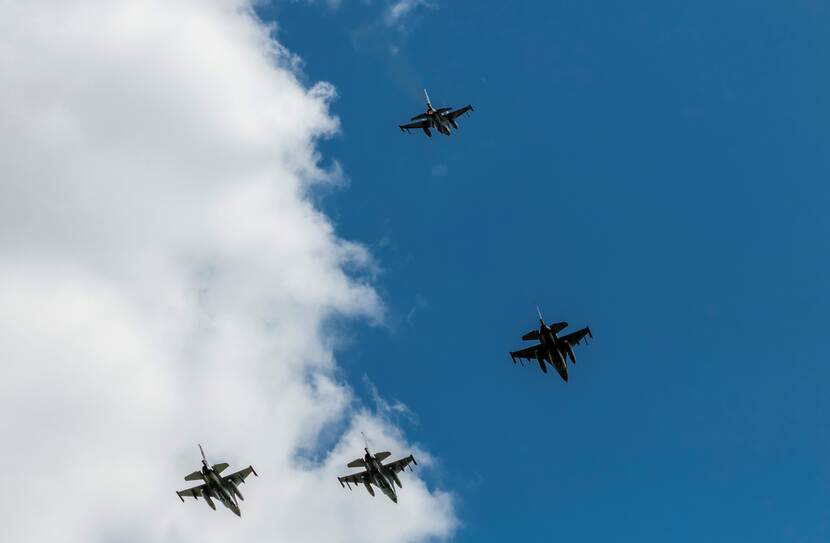 4 F-16's tegen een halfbewolkte lucht.
