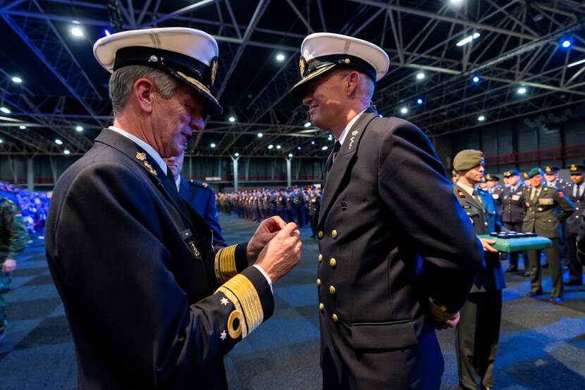 Viceadmiraal Boots gaat de medaille opspelden bij een marineman.