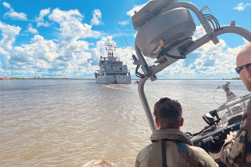 Zr.Ms. Pelikaan arriveert bij Paramaribo, gezien vanuit een snelle RHIB-motorboot.