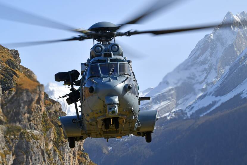 Helikopter in de lucht tussen de bergen.