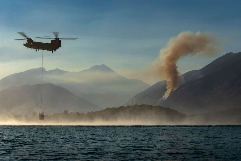 Een Chinook vult een bambi bucket in Albanië.