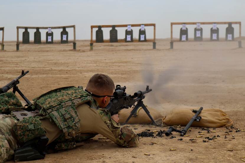 Op de grond liggende militair schiet op schietschijf.