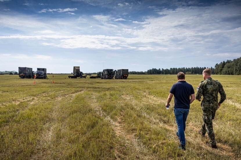 De staatssecretaris loopt richting een Patriot-lanceersysteem.