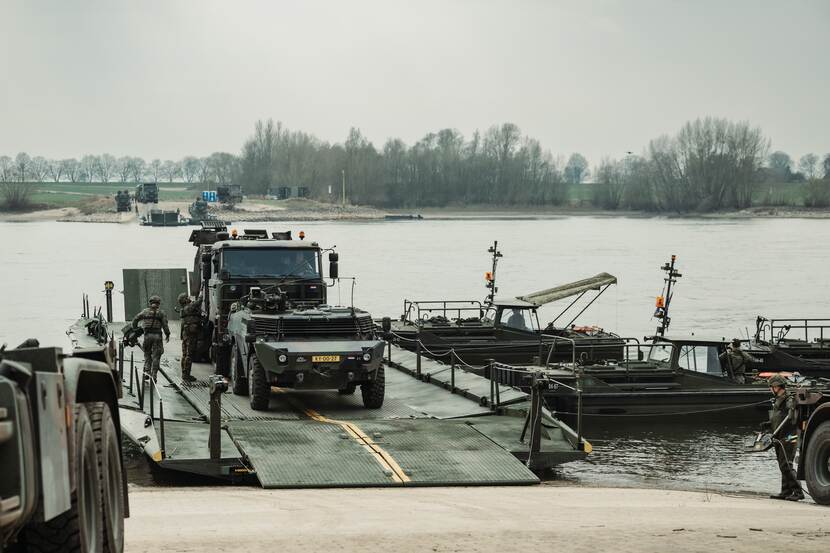 Militairen steken met voertuigen de Rijn over tussen Kalkar en Emmerich.