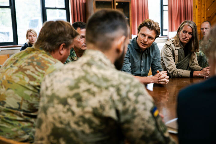 Minister Brekelmans aan tafel in overleg met militairen.