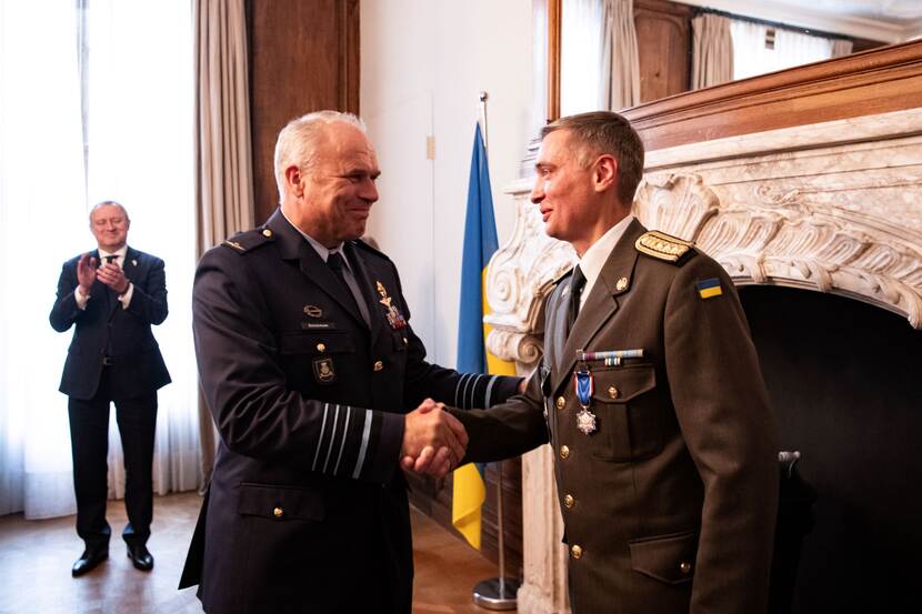 CDS Onno Eichelsheim feliciteert de Oekraïense defensieattaché  Yurii Herashchenko met zijn Ereteken voor Verdienste in het Zilver. Op de achtergrond de ambassadeur van Oekraïne .