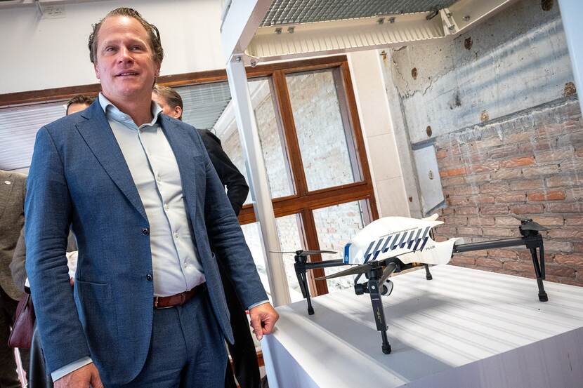 Staatssecretaris Tuinman staat naast een tentoongestelde drone.