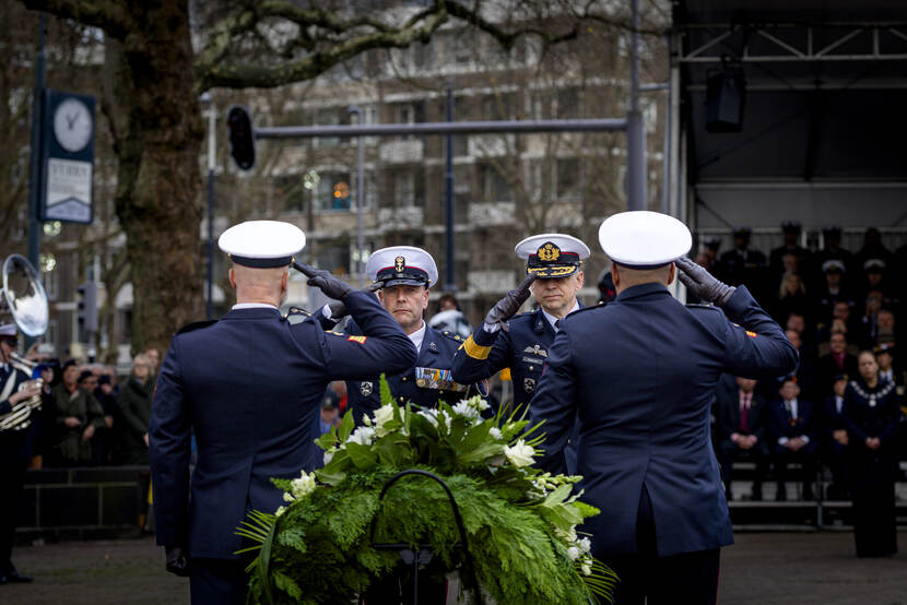 Militairen salueren bij herdenking.