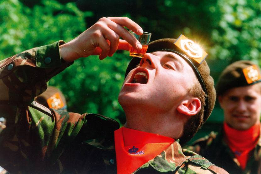Een militair drinkt een glaasje Calvados, een brandewijn uit Normandië. Archieffoto: ministerie van Defensie.