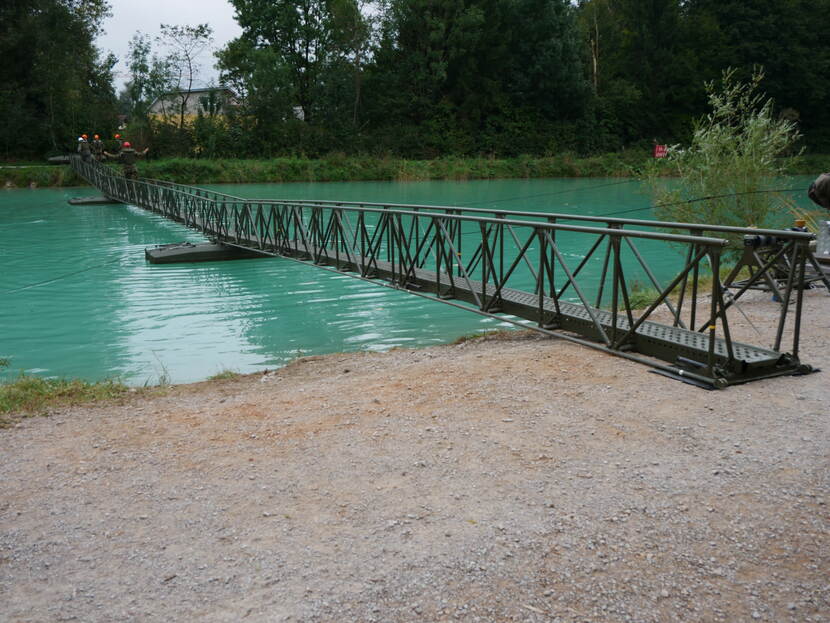 Militairen steken de Mamba-infanteriebrug over. De infanteriebrug is opgezet over water.