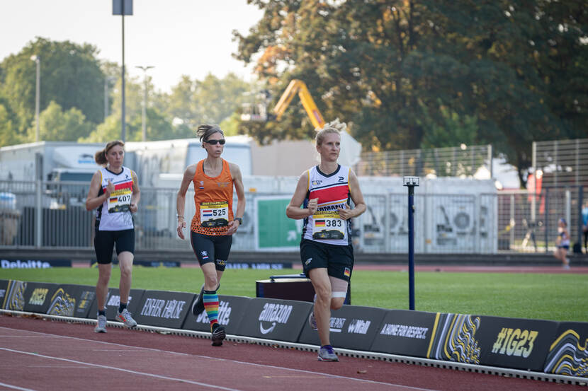 3 dames rennen op de atletiekbaan.