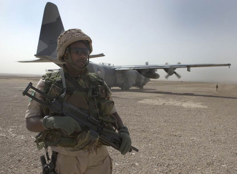 Militairen in verdedigende positie na landing C-130 Hercules op airstrip Tarin Kowt.