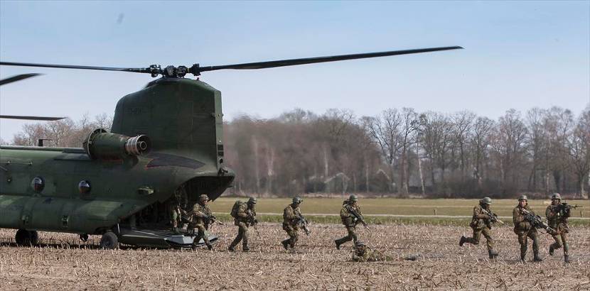 Militairen verlaten een Chinook-transporthelikopter.