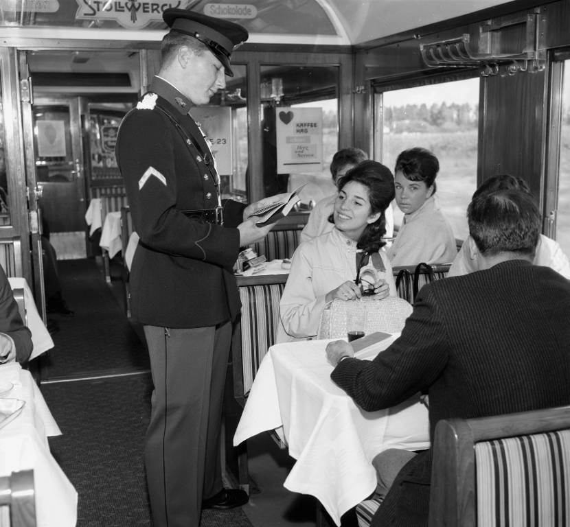 Historische foto: een marechaussee controleert papieren in een trein.