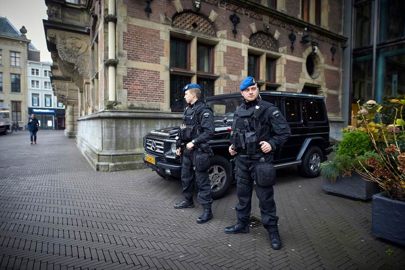 2 marechaussees van Hoog Risico Beveiliging beveiligen een gebouw.